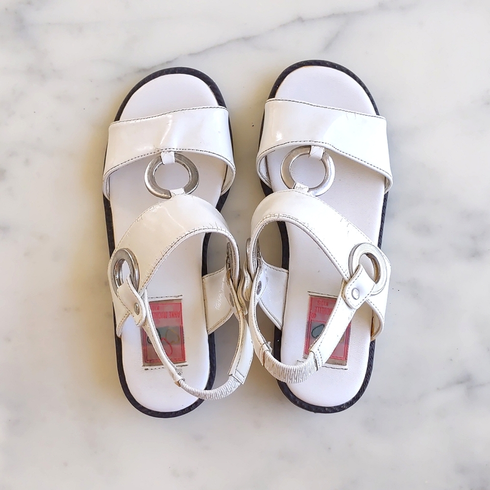 Toddler Girl's White Sandals with silver decorations.